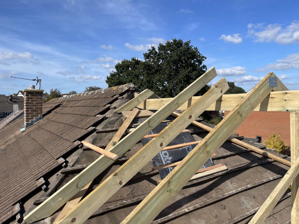 Professional roofers installing a new roof on a house in Bristol.