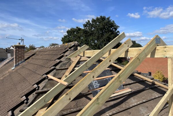 Professional roofers installing a new roof on a house in Bristol.