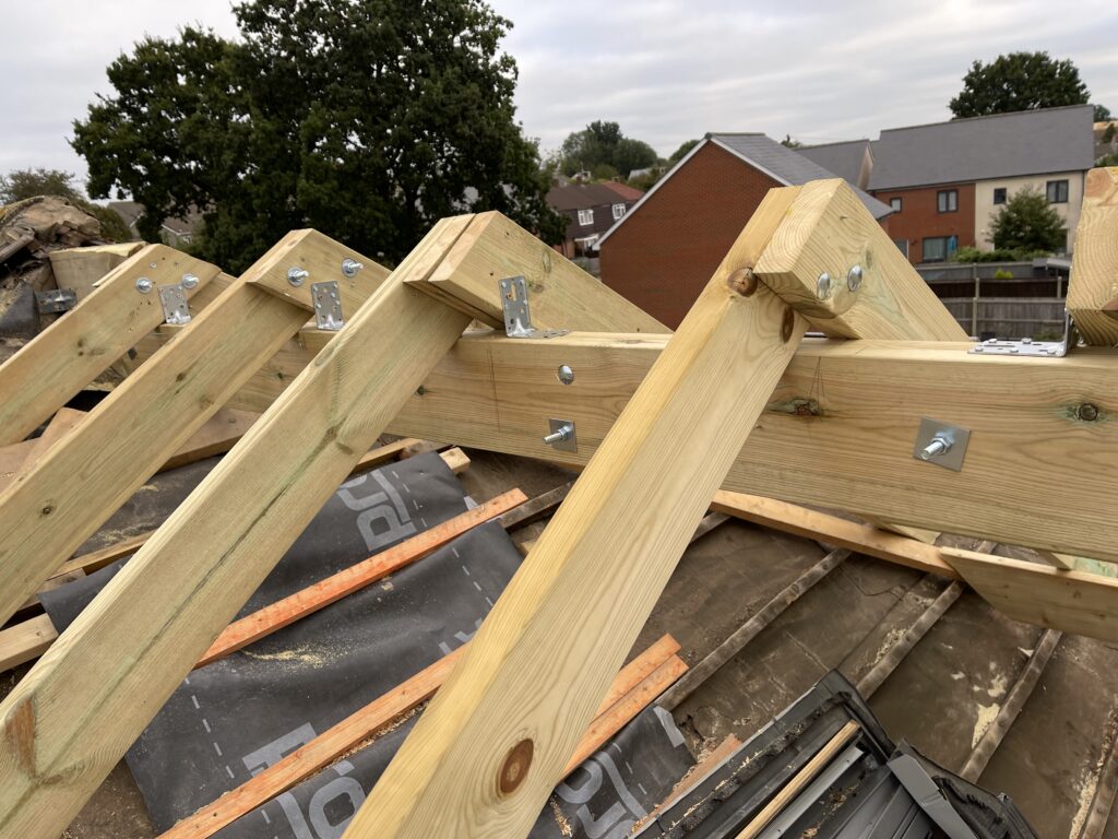 Professional roofers installing a new roof on a house in Bristol.